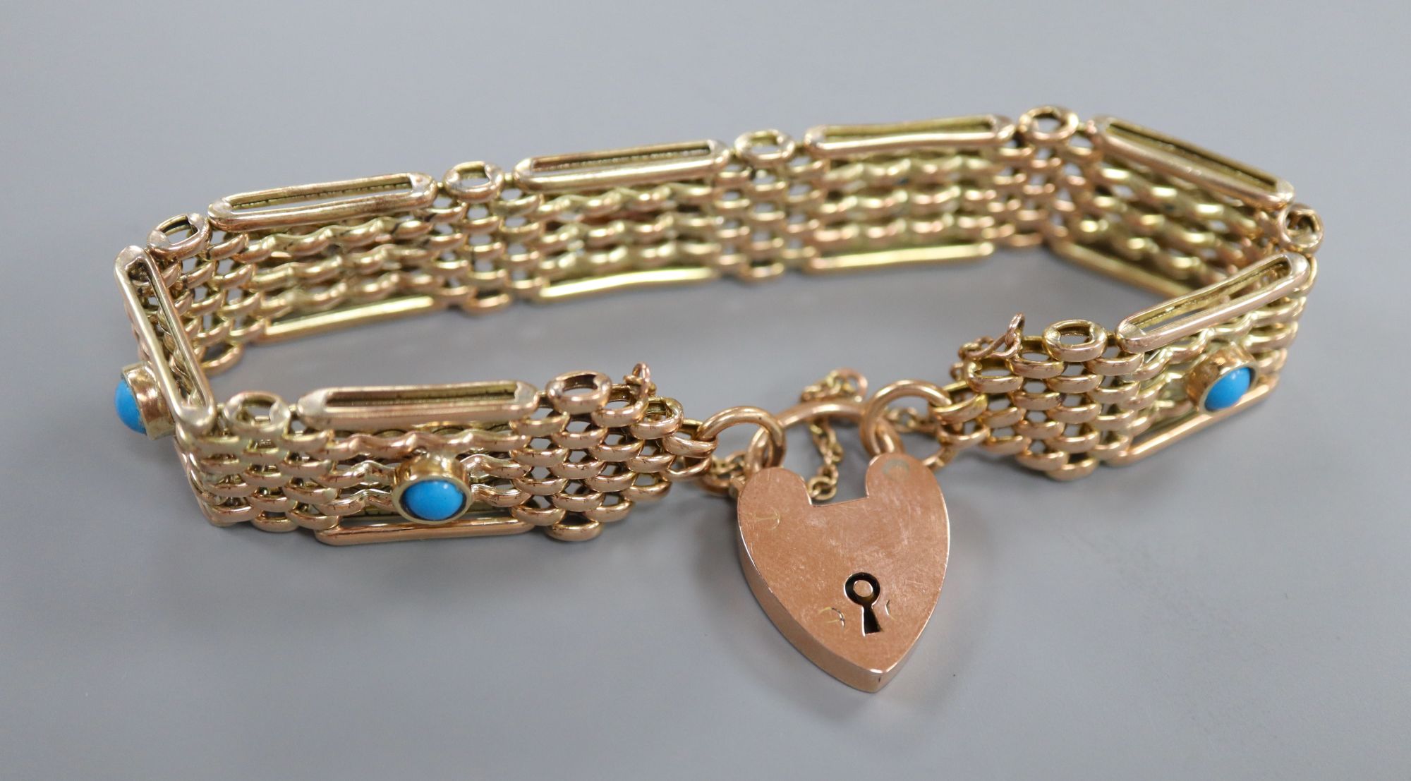 An early 20th century 9ct and seven stone turquoise set gatelink bracelet, approx. 18cm, gross 18.8 grams.